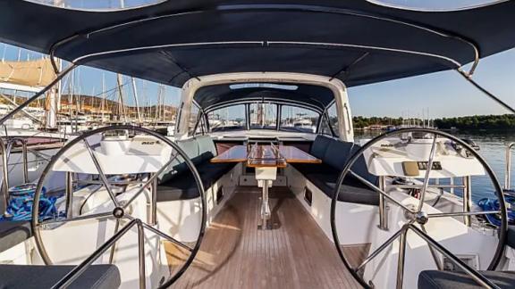 The spacious cockpit of the Tourbillon sailing yacht offers a comfortable seating and dining area.