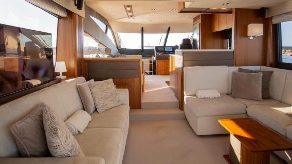 Among Nice yacht charter options Turquoise motor yacht shows spacious lounge with sofas and open layout.