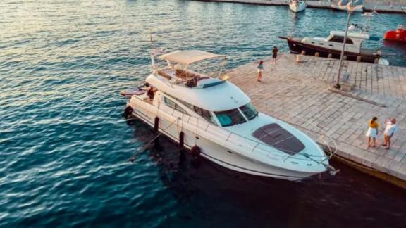 The motor yacht Unplugged docked at the port in the evening.