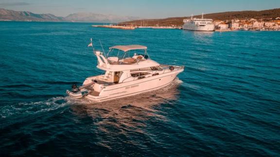 The motor yacht Unplugged heading towards the port at sunset.