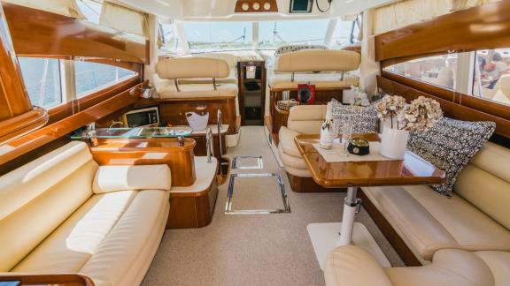 Spacious and comfortable interior lounge of motor yacht Unplugged with elegant details.