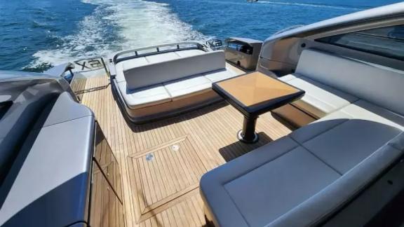 The seating area on the aft deck of motor yacht Urus features comfortable seats and a stylish table.