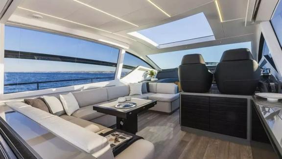 The salon of motor yacht Urus features a spacious seating area, modern design, and large windows with sea views.