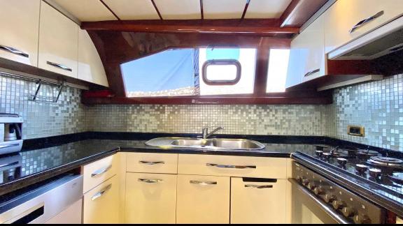 The Vedo B yacht features a modern kitchen with fully equipped appliances and ample counter space.