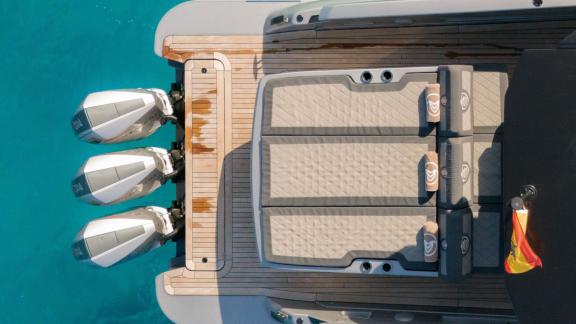 Anchored in Ibiza, Vibe is seen with spacious sunbathing cushions on the aft deck.