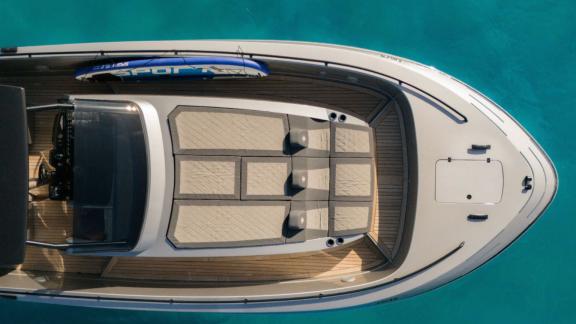 Vibe is anchored in Ibiza, showcasing spacious sunbathing cushions on the foredeck from above.
