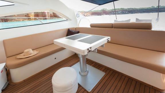 The modern and comfortable seating and dining area of motor yacht Vida Boa offers tranquility with a sea view.