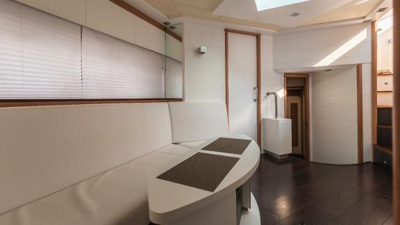 The spacious and bright seating area of motor yacht Vida Boa offers a modern and airy ambiance.