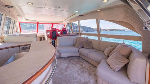 The salon of motor yacht Vintage offers a spacious seating area with a view of the captain’s cabin.