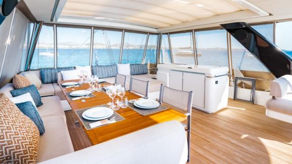 The spacious dining area on White Caps catamaran offers comfortable seating and a scenic dining experience.