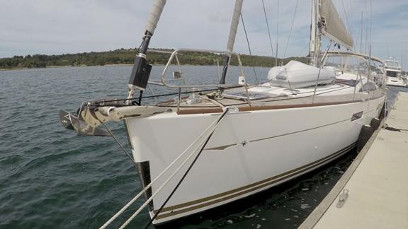 The Whyknot yacht is docked, standing out with its elegant appearance on the water.