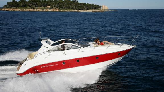 Motor yacht Xenia cruising at high speed in open waters, offering an exhilarating sea experience.