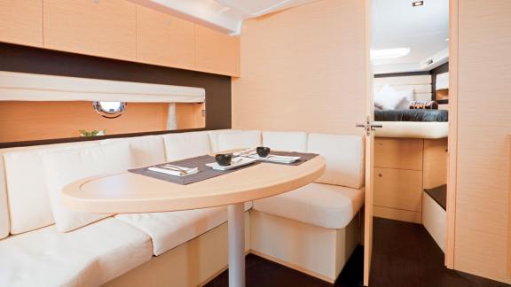 Modern interior dining area on motor yacht Xenia with a comfortable seating arrangement.