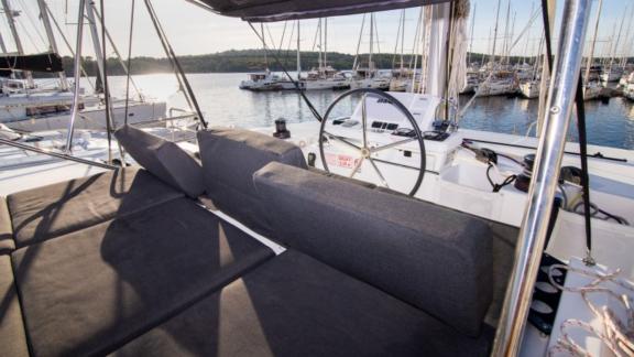 The flybridge of the Lagoon 50 offers comfortable seating and a stunning view of the marina.