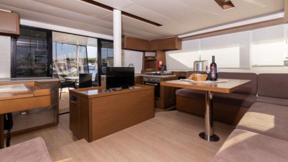 The Lagoon 50 offers an elegant interior with a stylish dining area and modern kitchen, perfect for cozy evenings.