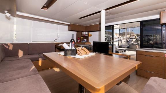 The comfortable salon of the Lagoon 50 with a modern dining area and plenty of natural light, perfect for relaxing and e