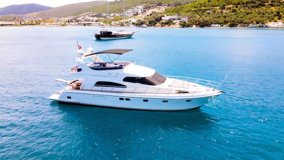 Motor yacht Zeus 1 is seen near the shore.