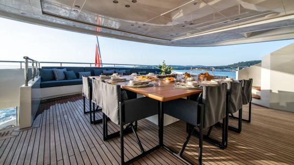 Enjoy a stylish dinner on your yacht with stunning sea views.