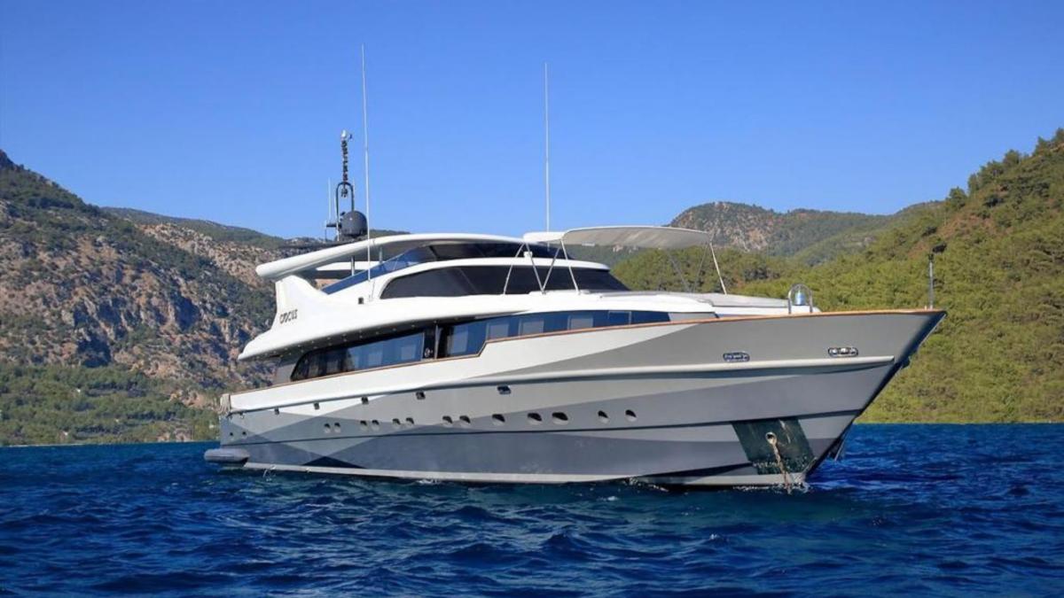 The luxury yacht on the sea is cruising on a beautiful day, accompanied by waves.