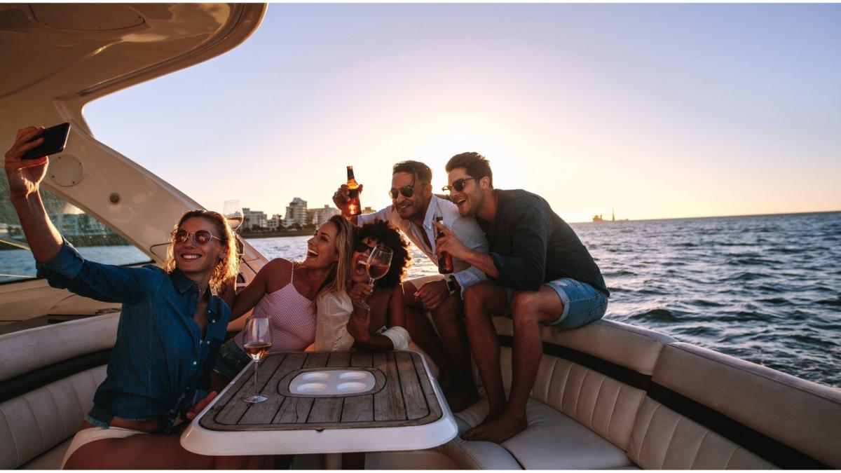 A packed group joins the party on the boat and immortalises the moment with photos.