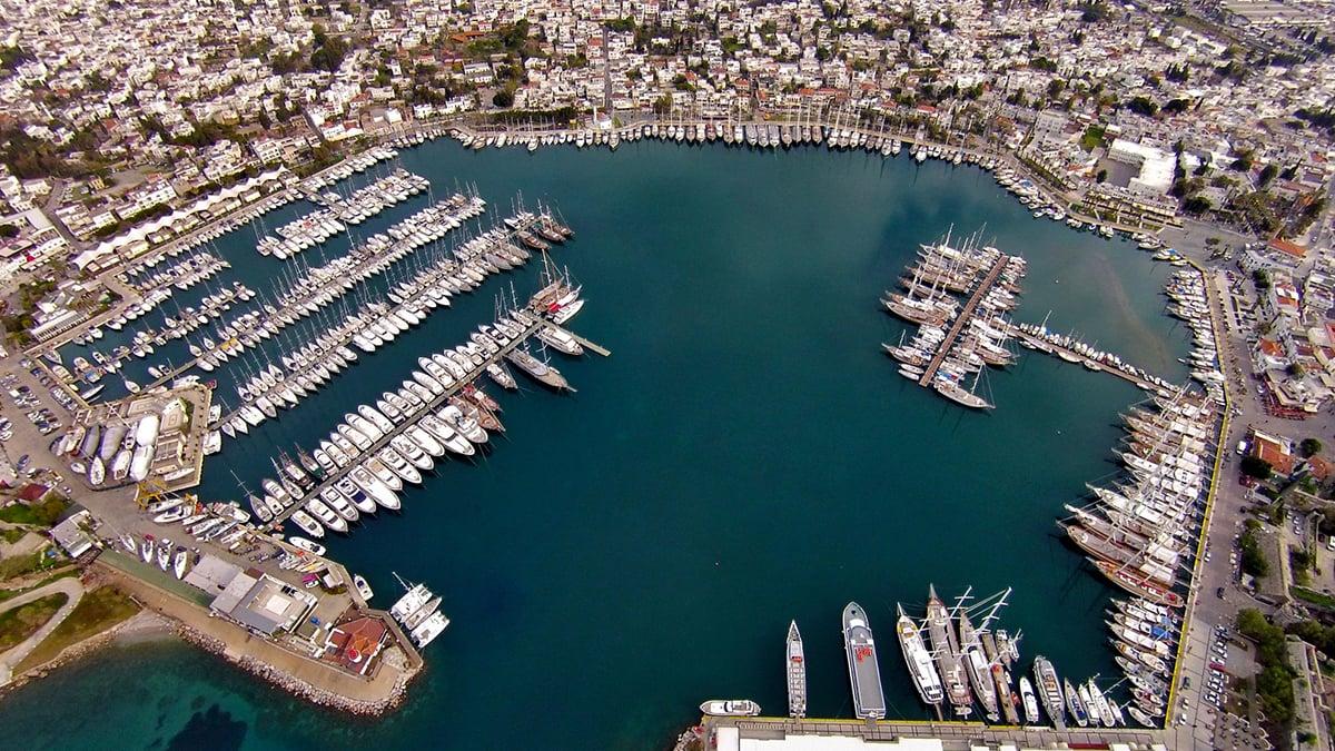 Stunning aerial view of a marina filled with yachts, perfect for an exclusive yacht holiday.