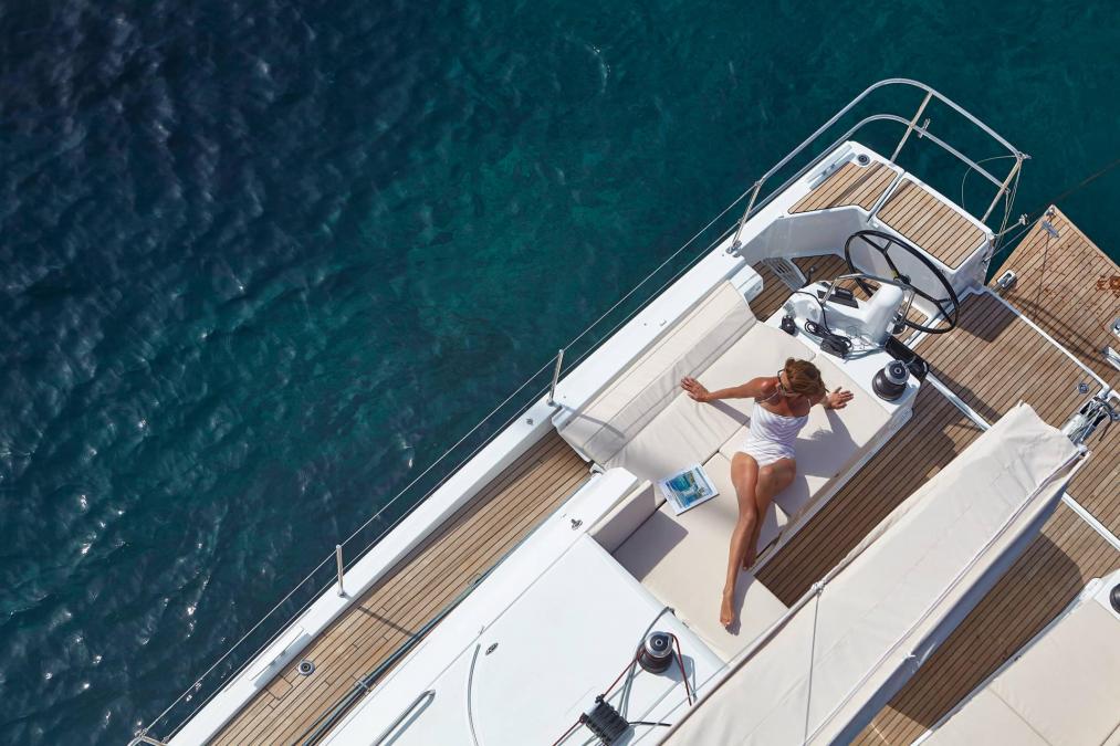 Woman relaxing on a yacht with turquoise water view