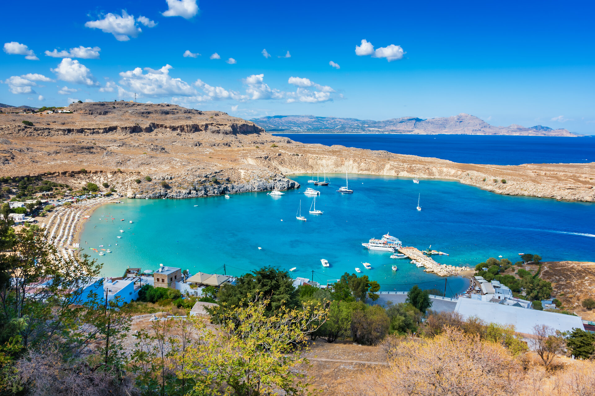 Blick auf die St. Paul's Bay in Lindos, der ideale Ankerplatz für eine exklusive katamaran tour rhodos im Sommer