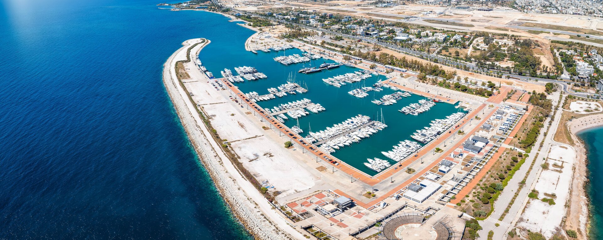Aerial view of Agios Kosmas Marina for a luxury motor yacht charter Athens with white yachts in the basin