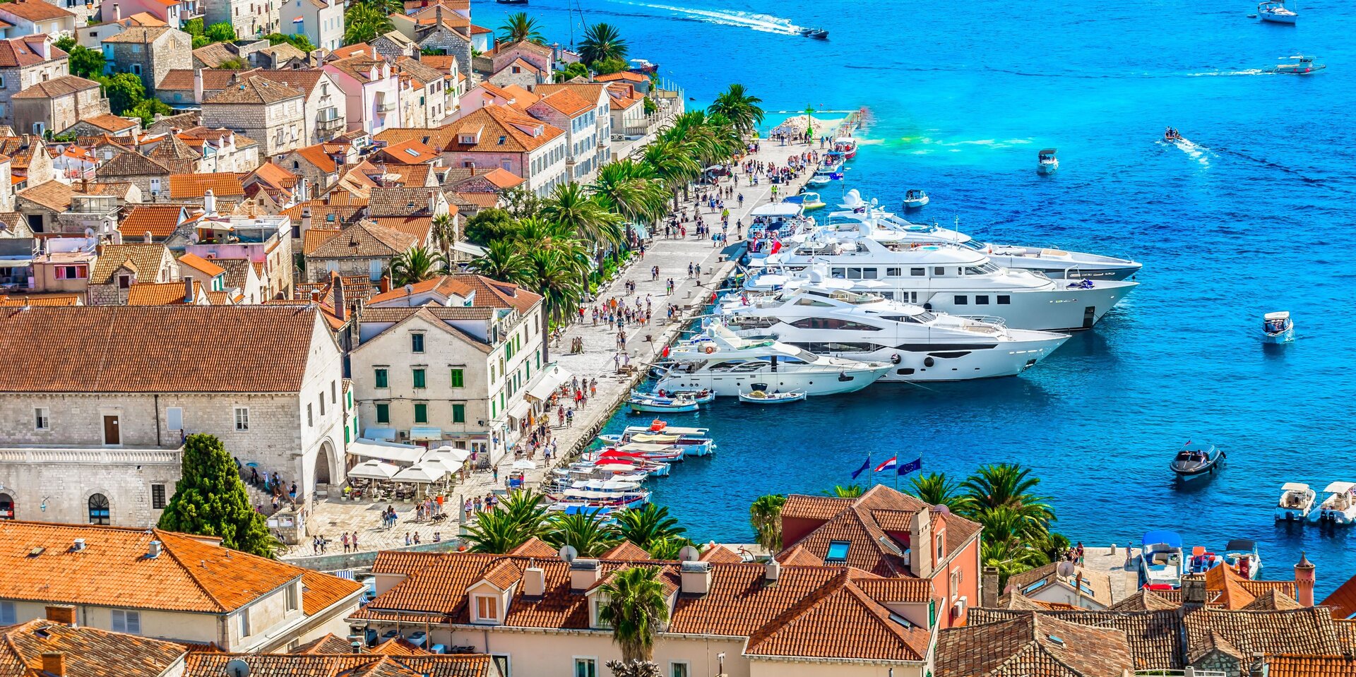 Motor yacht charter Croatia with luxury yachts in historic old town harbor and crystal clear Adriatic sea