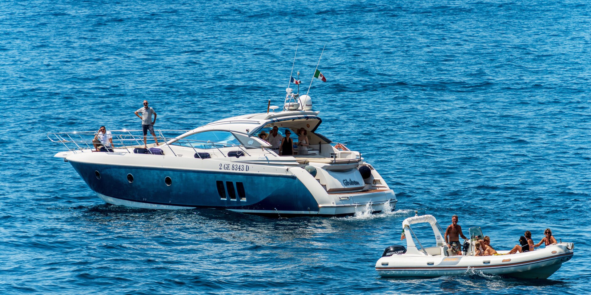 Eine blaue Motoryacht und ein Beiboot auf dem offenen Meer beim Motoryacht mieten in Fethiye