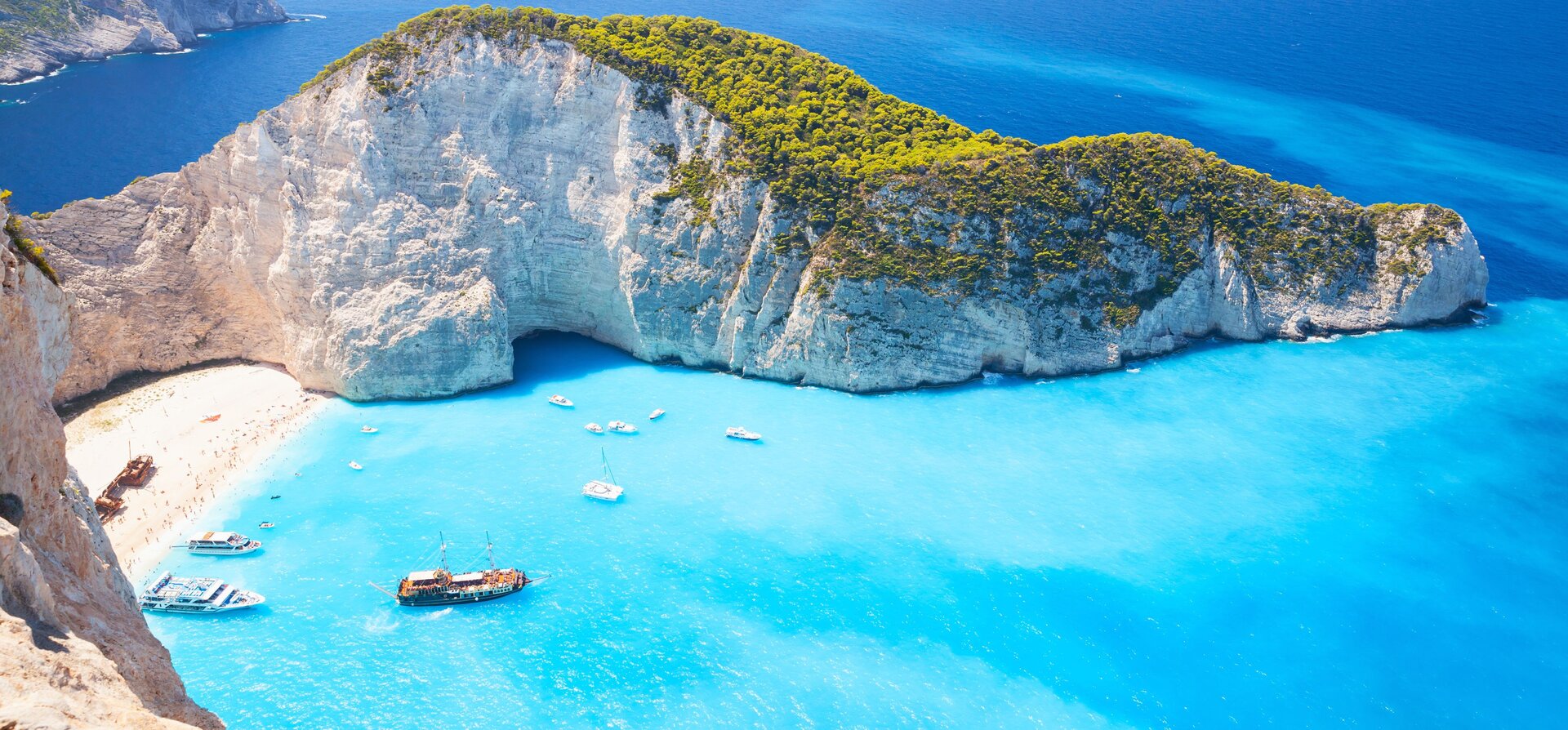 Aerial view of Navagio shipwreck and turquoise water, the highlight of your yacht charter Zakynthos